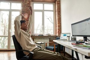 happy person watching incline on computer screen. cloud ERP small Business