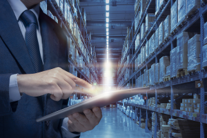 person using tablet computer in warehouse,